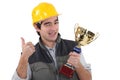 Craftsman winking holding trophy Royalty Free Stock Photo