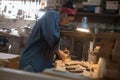 Craftsman woman works in a wood workshop. Handmade concept