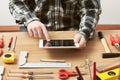 Craftsman working on a DIY project with his tablet Royalty Free Stock Photo