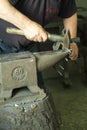 A craftsman working with a hammer and anvil Royalty Free Stock Photo