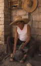 Craftsman working in his workshop, carving the stone to make molcajetes, traditional Mexican crafts to grind chili peppers, avocad Royalty Free Stock Photo