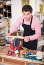 Craftsman working on woodworking machine