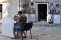 The craftsman works in a store in Bukhara.