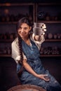 Potter female admires the work done in a pottery workshop. Pottery workshop. Royalty Free Stock Photo