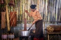 Craftsmen of Thai Silk. Older women dye silk with colors from volcanic soil. Phu fabric dyeing volcanic igneous or soil. Buriram, Royalty Free Stock Photo