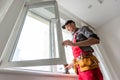 craftsmen workers install a window in the house rattle with a special rubber hammer Royalty Free Stock Photo