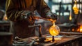 Craftsperson manipulating molten glass with tongs