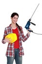 Craftswoman holding a drill Royalty Free Stock Photo