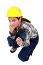 Craftswoman holding a drill Royalty Free Stock Photo