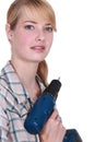 Craftswoman holding a drill Royalty Free Stock Photo