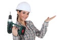 Craftswoman holding a drill Royalty Free Stock Photo