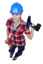 Craftswoman holding a drill Royalty Free Stock Photo