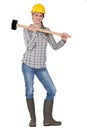 Craftswoman holding a huge hammer Royalty Free Stock Photo