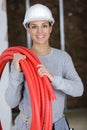 craftswoman holding red hose Royalty Free Stock Photo