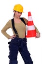 Craftswoman holding traffic cone