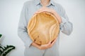 Craftswoman showing wooden bowl, she made. Holding it vertically Royalty Free Stock Photo