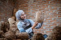 craftswoman in veil looking at woven water hyacinth crafts