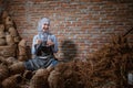 craftswoman in veil with thumbs up among woven water hyacinth