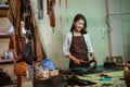 craftswoman working with leather cloth on a table