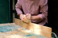 Craftswoman working with old wooden jointer plane, wood shaving concept Royalty Free Stock Photo