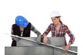Craftswomen measuring a wall Royalty Free Stock Photo