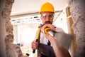 Crafty handyman wearing yellow helmet