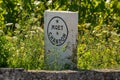 Cramant, France, 18 July 2021, white stone territory marking signs of Champagne house Moet&Chandon and view on green chardonnay