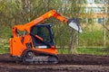 Cramo mini loader leveling the ground in the park