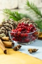 Cranberries in a glass plate. Frozen lingonberries in a glass plate on a wooden table.