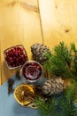 Cranberries in a glass plate. Frozen lingonberries in a glass plate on a wooden table.