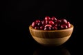 Cranberries in wooden bowl isolated on black background.copy space Royalty Free Stock Photo