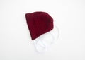 Cranberry colored baby bonnet knit Royalty Free Stock Photo
