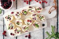 Cranberry, cream cheese roll-up appetizers, top view on a white platter