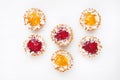 Cranberry and pumpkin mini tarts on white background