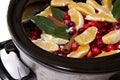 Cranberry sauce with oranges, cinnamon and bay leaf simmering in Royalty Free Stock Photo