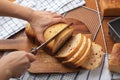 Cranberry whole wheat bread loaf with woman hand slicing