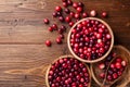 Cranberry in wooden bowl on rustic table top view Royalty Free Stock Photo