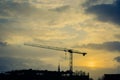 Crane on anonymous city in sundown Royalty Free Stock Photo