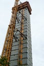 Crane attached to side of building at downtown construction site Royalty Free Stock Photo
