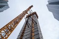 Crane attached to side of building at downtown construction site Royalty Free Stock Photo