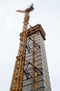 Crane attached to side of building at downtown construction site Royalty Free Stock Photo