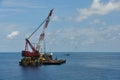 Crane barge lifting heavy cargo or heavy lift in offshore oil and gas industry. Large boat working for lift piping