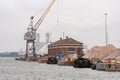 A crane, barges, warehouse and ballast at the Port of Southampton in Hampshire, UK Royalty Free Stock Photo