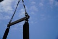 Crane boom with isolated hook, blue sky background,Elements of crane: hook, loop, chain, connecting parts Royalty Free Stock Photo