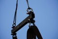 Crane boom with isolated hook, blue sky background,Elements of crane: hook, loop, chain, connecting parts Royalty Free Stock Photo