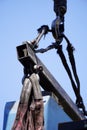 Crane boom with isolated hook, blue sky background,Elements of crane: hook, loop, chain, connecting parts Royalty Free Stock Photo