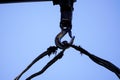 Crane boom with isolated hook, blue sky background,Elements of crane: hook, loop, chain, connecting parts Royalty Free Stock Photo