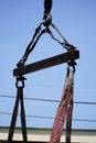 Crane boom with isolated hook, blue sky background,Elements of crane: hook, loop, chain, connecting parts Royalty Free Stock Photo