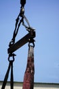 Crane boom with isolated hook, blue sky background,Elements of crane: hook, loop, chain, connecting parts Royalty Free Stock Photo