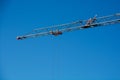 crane boom with rope in front of deep blue sky typical construction site background Royalty Free Stock Photo